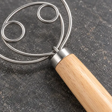 The whisk wire junction, smooth silver collar and oak handle